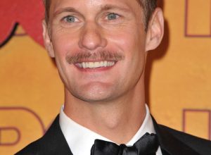 alexander skarsgard and his completely misguided facial hair smile stupidly on the emmy's red carpet