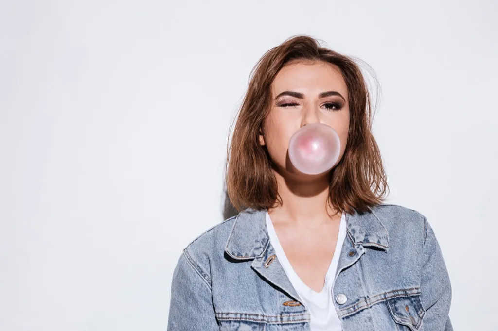 Woman blowing bubble with her gum