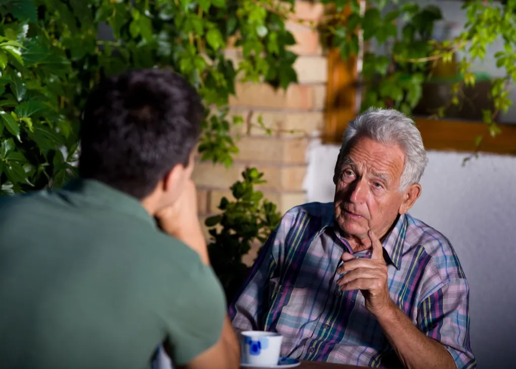 young man talking to a talkative old man