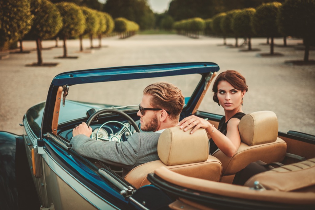 billionaires under 40 rich couple driving a car
