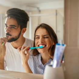 couple brushing teeth