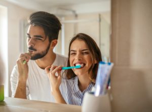 couple brushing teeth