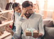 girl giving unusual gifts to dad man