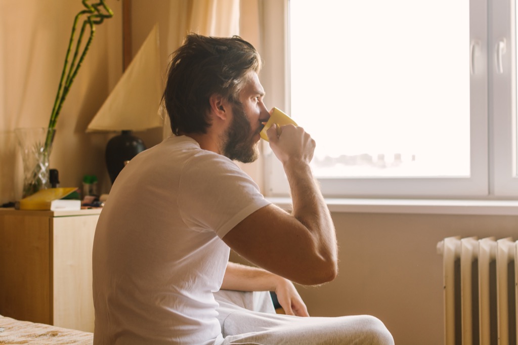 Man drinking coffee before a nap, a killer body clock hack.