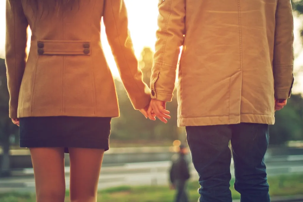 Couple holding hands outdoors college professor secrets