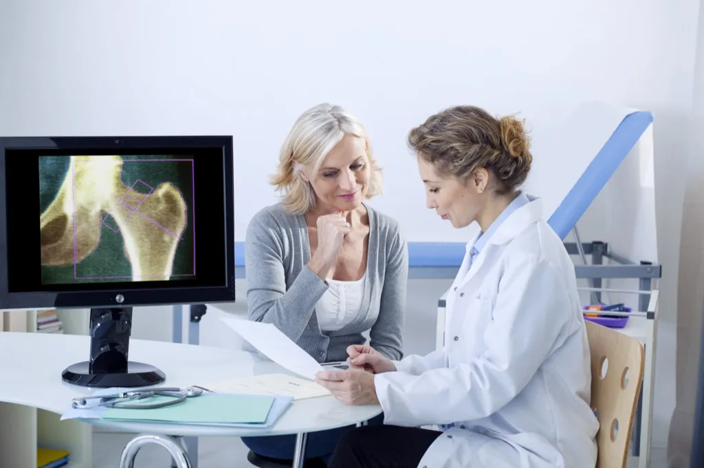 woman talking to her doctor about bones, ways your body changes after 40