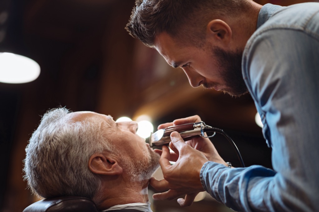 man getting his beard trimmed - look younger