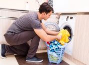 man putting clothes in washing machine laundry folding tips