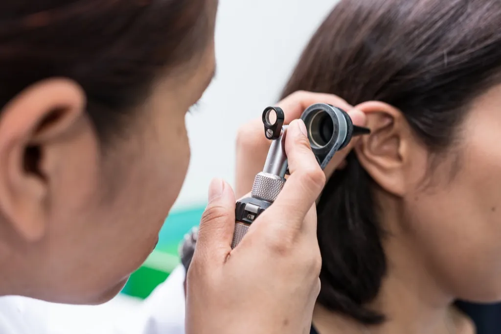 woman getting an ear exam, ways your body changes after 40