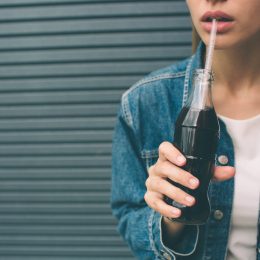 woman drinking soda, a bad habit after 40