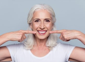 older white woman smiling showing off perfect teeth