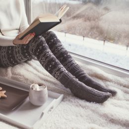 woman cozy reading in her bed stay sharp