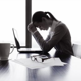 stressed out woman at a desk feeling guilty