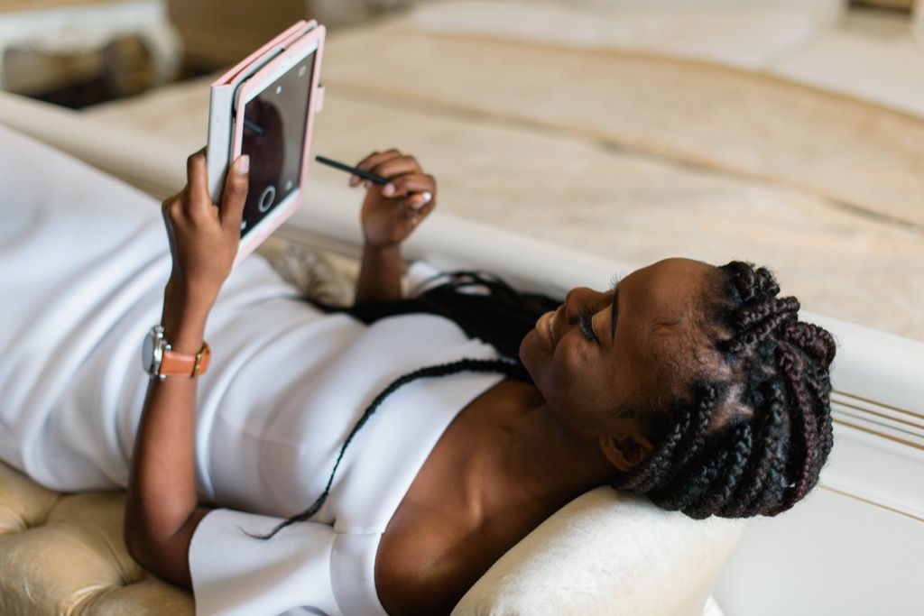 woman using tablet on sofa long-distance relationships