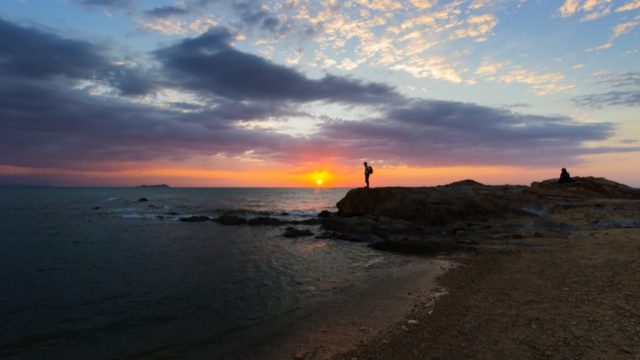 Man on beach at sunset, showing balance
