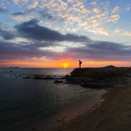 Man on beach at sunset, showing balance