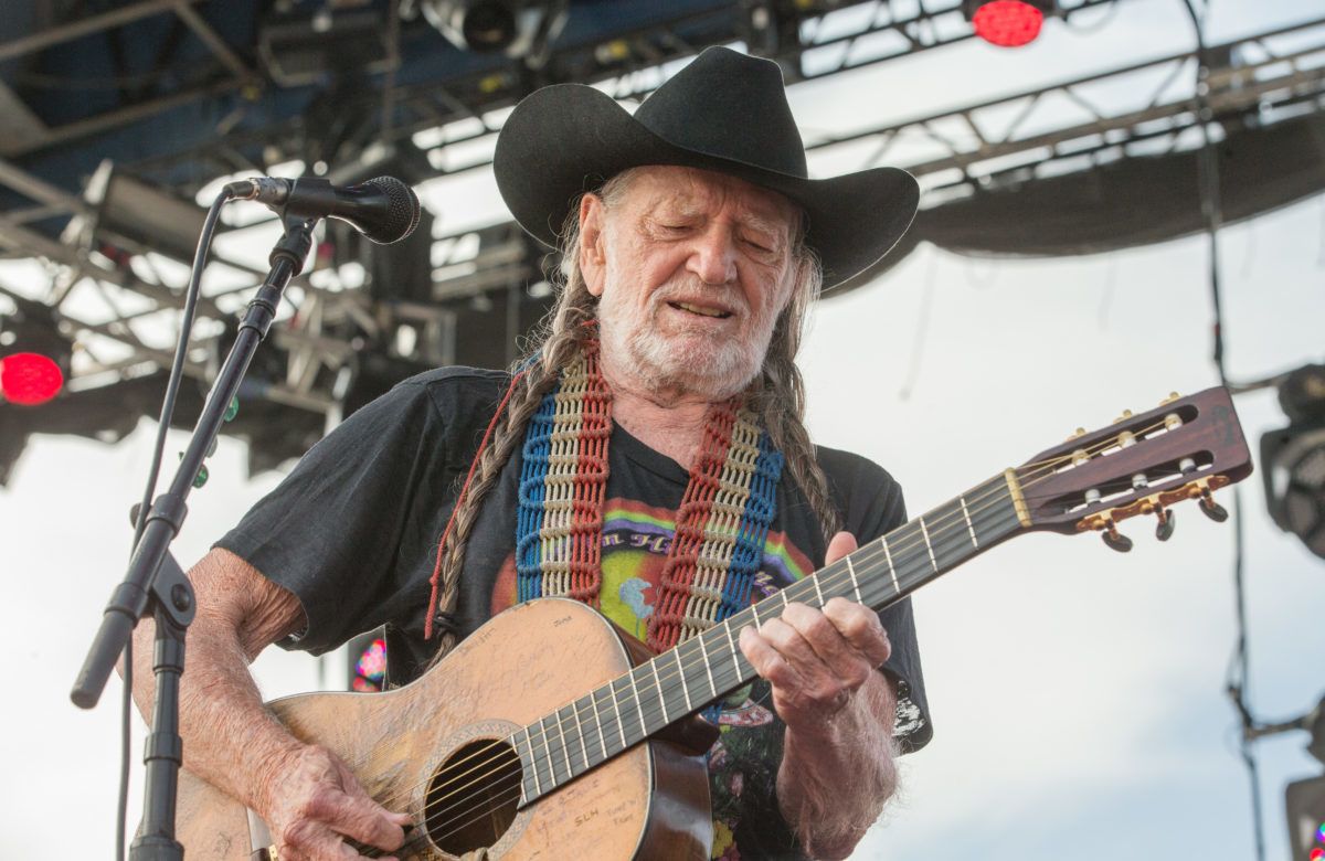 Willie Nelson performing on stage