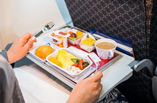 woman getting ready to eat her airplane food