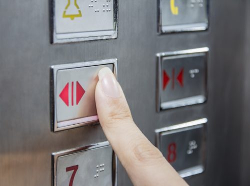 woman pressing elevator button