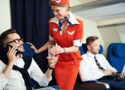 flight attendant helping a first class flyer