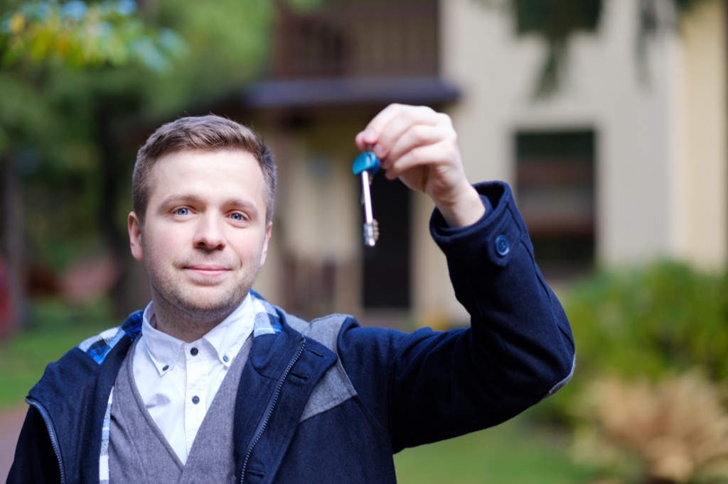 Home buyer holding his new keys.