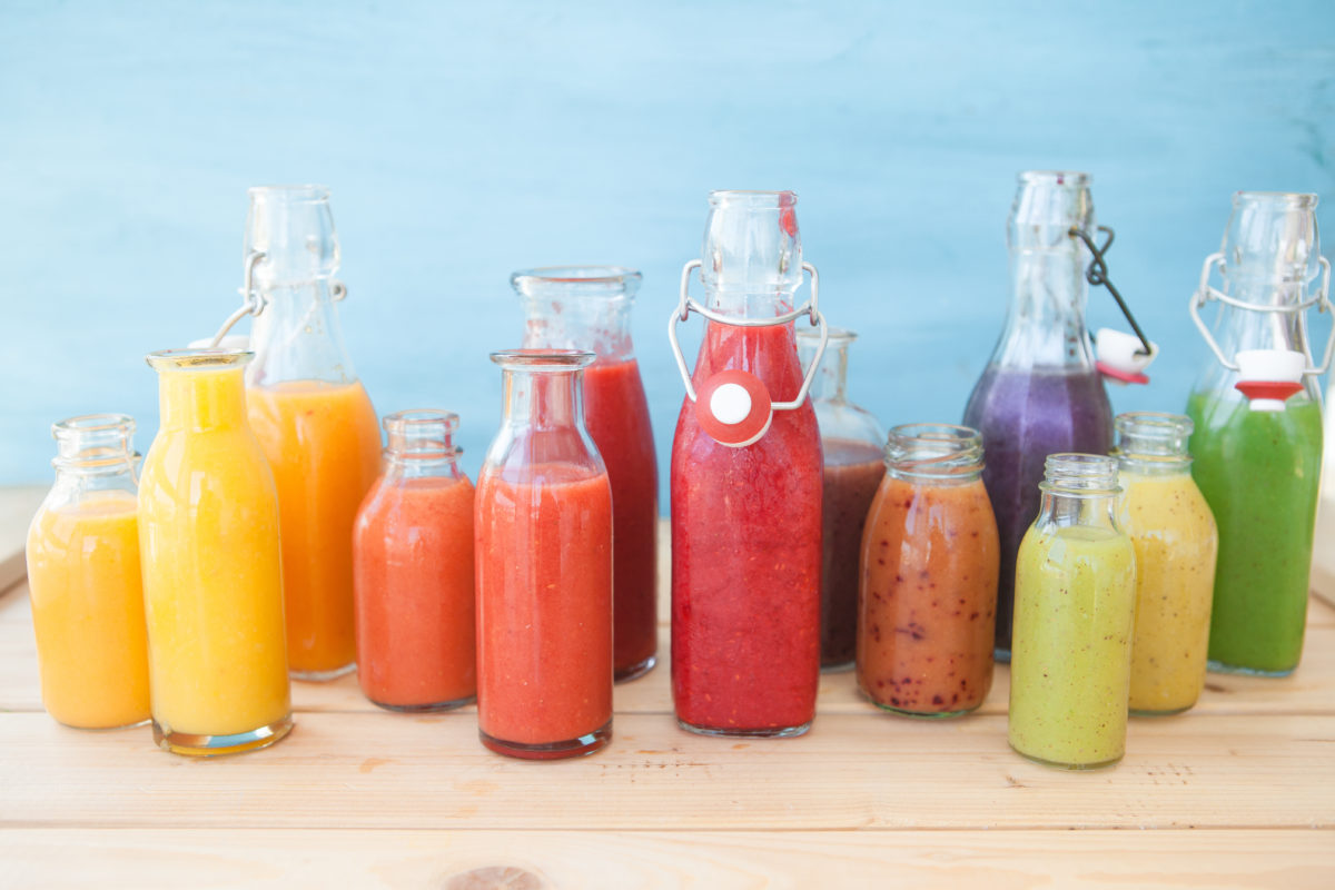 assortment of colorful fruit juices on a table, weight loss motivation