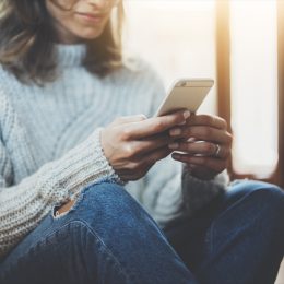 woman typing on her phone,