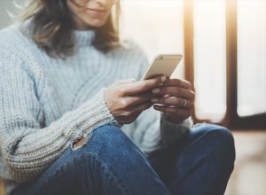 woman typing on her phone,