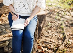 woman writing in journal health tweaks over 40