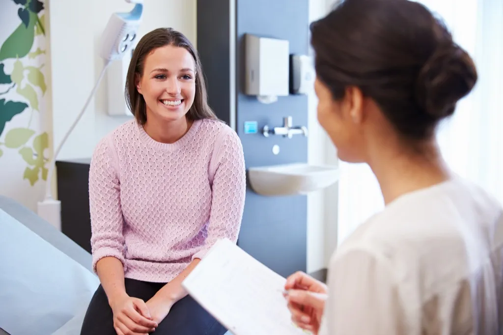 Smiling woman at doctor - gynecologist secrets 