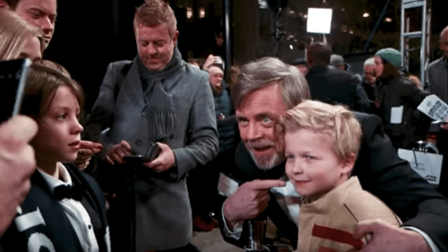 Mark Hamill hugs child in star wars: the last jedi premiere.