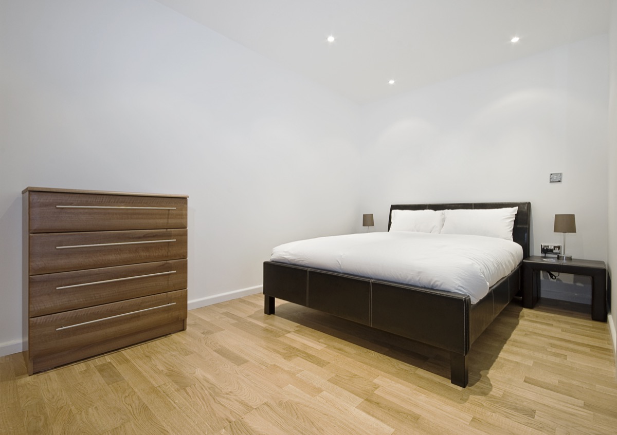 a bedroom with matching dark wood furniture