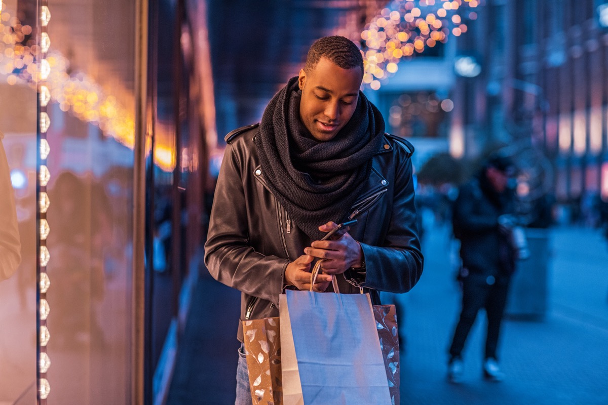 Black man enjoying winter shopping