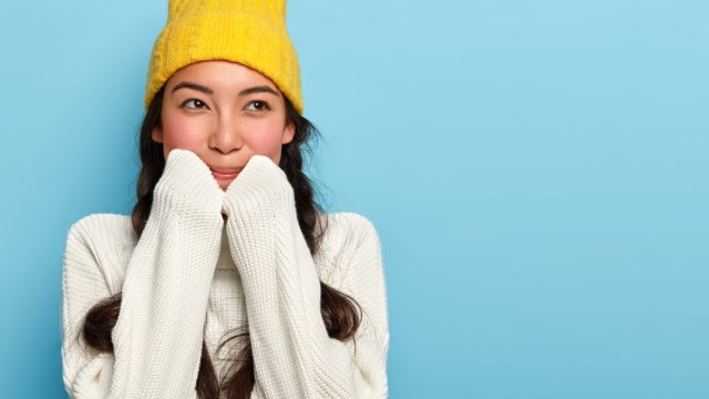 Happy cozy girl in hat and turtleneck