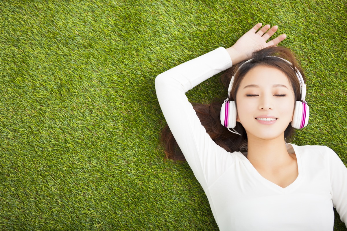 woman listening to music with headphones on exercises for mental health
