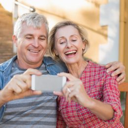 older couple taking photo, relationship white lies