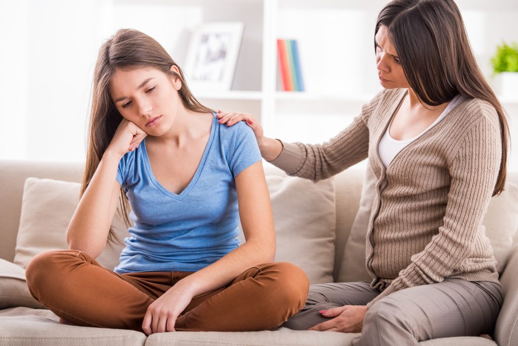 mother and daughter on couch Worst Things to Say to Kids