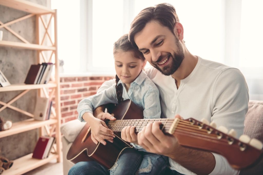 Dad Teaching Daughter How to Play Guitar