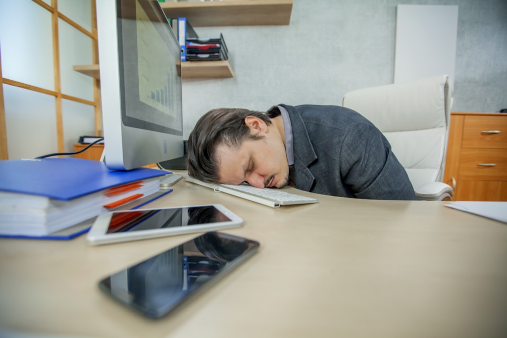 man sleeping at work lies over 40