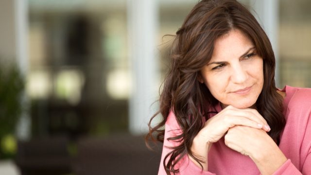 woman looking sad outdoors, worst things about an empty nest