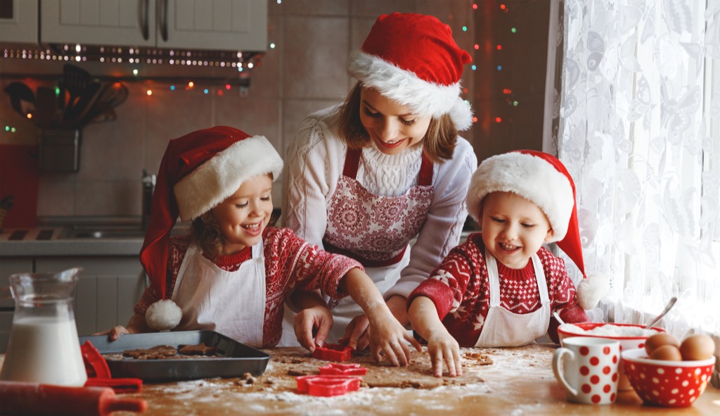 Mom and two children baking Christmas cookies