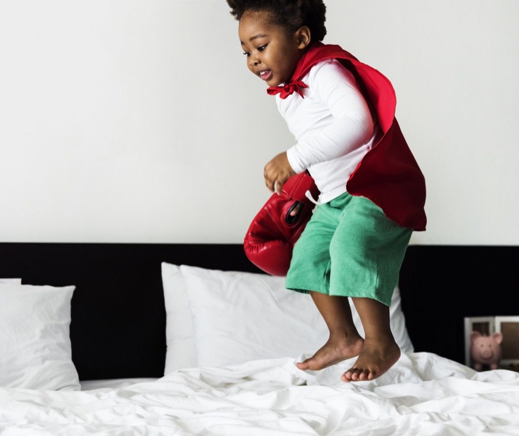 Kid jumping on bed