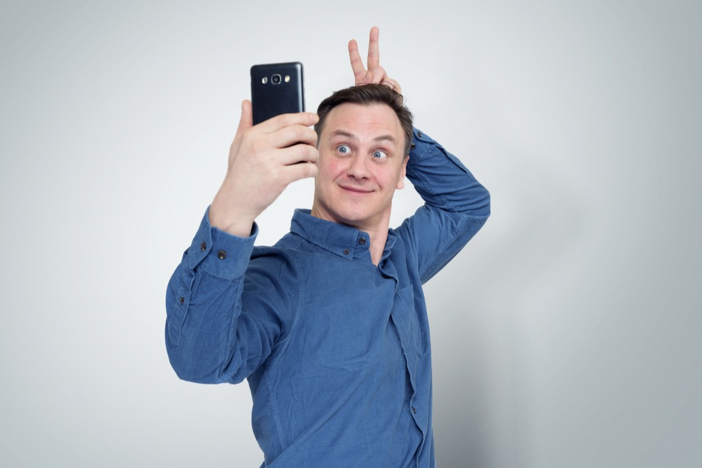 Online dating, man taking selfie
