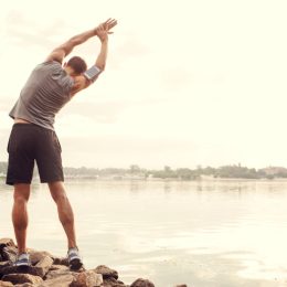 Runner stretching to boost his metabolism, exercise