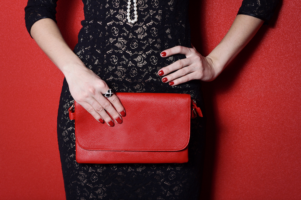 woman holding a red clutch