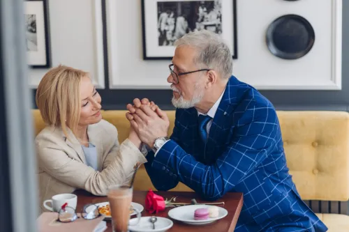 Older man complimenting woman on date