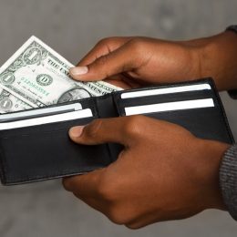 man taking money out of a wallet, parenting is harder