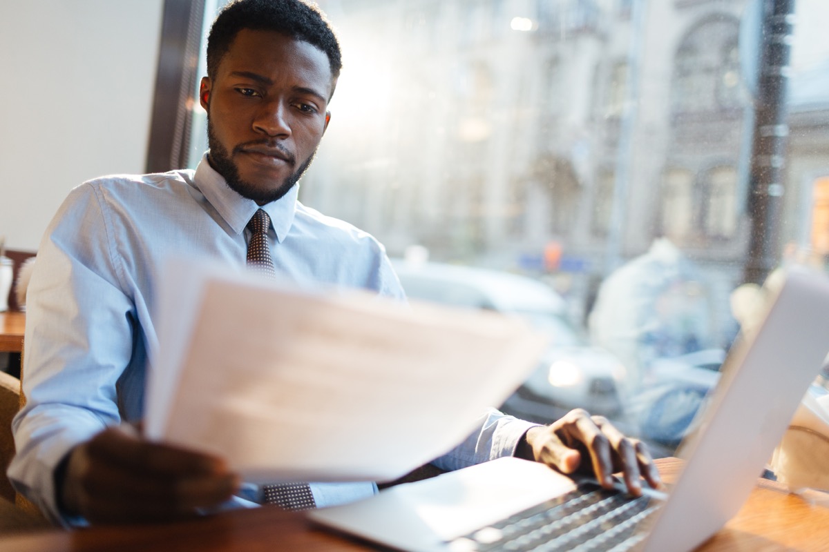 man looking over someone's resume, hiring manager tips