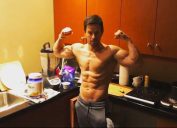 mark wahlberg looking ripped in his kitchen as he drinks whey protein