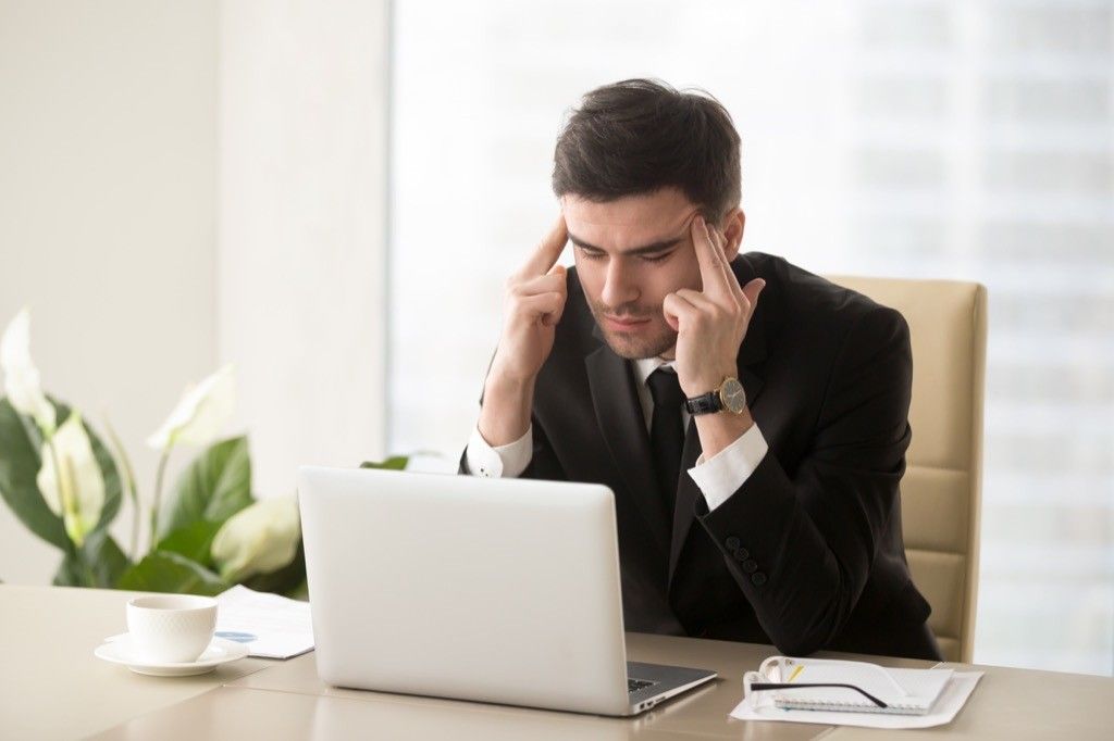 Stressed Man on Computer Signs Your Boss Wants to Fire You